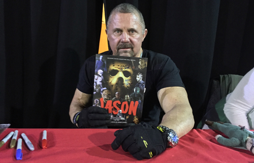 Kane Hodder with the Jason Souvenir Guide magazine from Classic Monsters