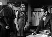 John Gray’s (Boris Karloff) presence makes 'Toddy' MacFarlane (Henry Daniell) increasingly uneasy, while Joseph (Bela Lugosi) is hatching plans of his own in The Body Snatcher (RKO 1945)