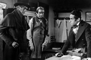 John Gray’s (Boris Karloff) presence makes 'Toddy' MacFarlane (Henry Daniell) increasingly uneasy, while Joseph (Bela Lugosi) is hatching plans of his own in The Body Snatcher (RKO 1945)