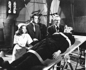 Nina (Jane Adams) and Larry Talbot (Lon Chaney) are a little concerned at Dr Edelmann’s (Onslow Stevens) interest in the Monster (Glenn Strange) in House of Dracula (Universal 1945)